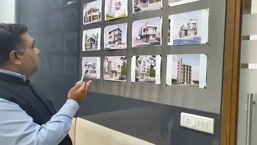 Girish S. Patel, founder of Sharda Engineers and Contractors, reviewing bungalow and building designs at the Ahmedabad office